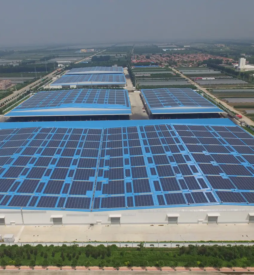 Aerial view of a manufacturing plant with rooftop solar panels